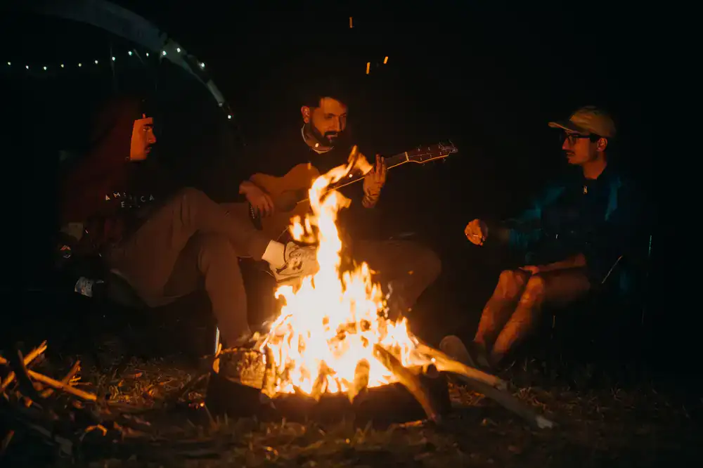 Players gathered around a campfire in a snowy wasteland